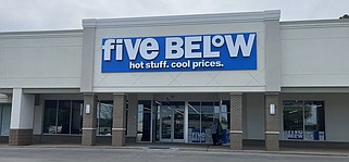 Staff Photo by Dave Flessner / Shoppers at the Highland Plaza shopping center Thursday look into the storefront being renovated for a new Five Below store scheduled to open May 3.